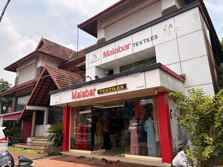 Building front-view with street-facing shops at nalukettu