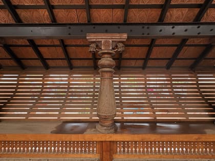 Wooden column, roof, and slatted exterior detail