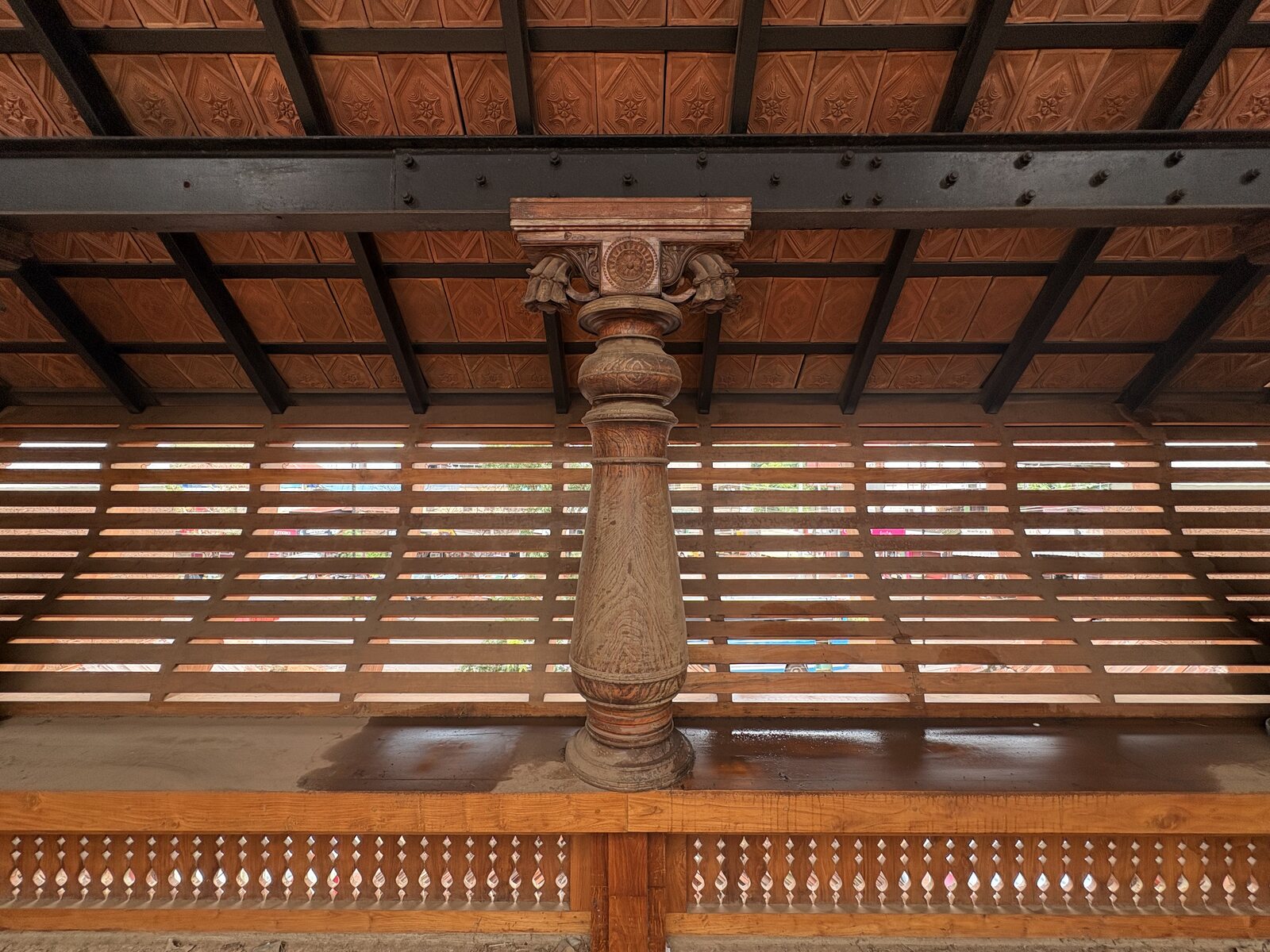 Wooden column, roof, and slatted exterior detail